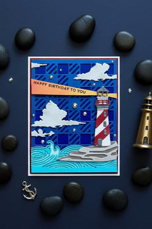 Lighthouse at Night card flat on dark navy with brass lighthouse figurine and moonlight