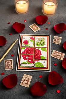 Rose XOXO card flat on dark charcoal with candlelight and vintage stamps