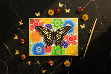 Black and Gold Butterfly card flat on black marble with gold butterfly confetti and rainbow florals