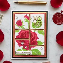 Rose XOXO card flat on white marble with red rose petals, vintage stamps and gold pen
